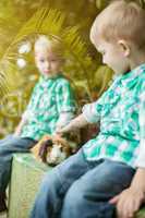 Image of twin boys posing with guinea pig