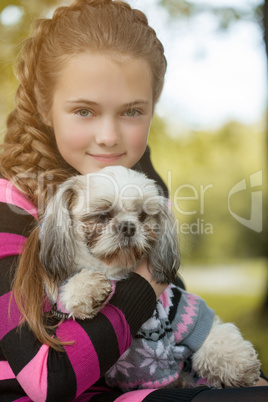 Portrait of beautiful little girl hugging her dog