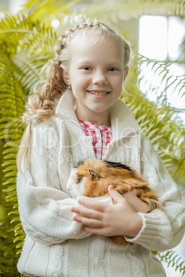 Portrait of smiling little girl posing with pet
