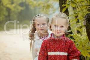 Image of two lovely girlfriends posing in park