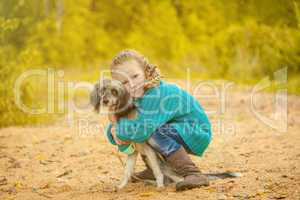 Image of pretty little girl hugging cute dog
