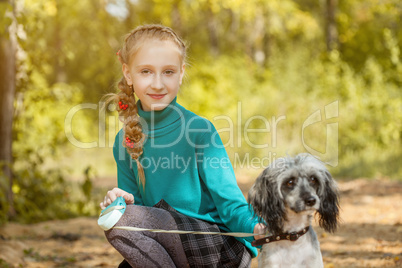 Cute smiling freckled girl posing with dog