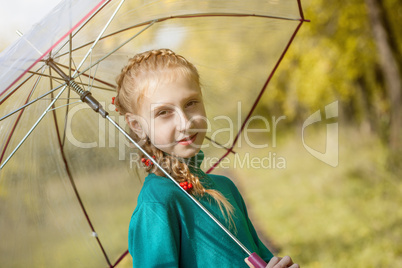 Smiling freckled girl posing with umbrella