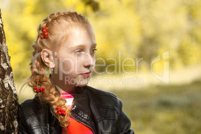 Cute girl posing with berries in pigtail, close-up