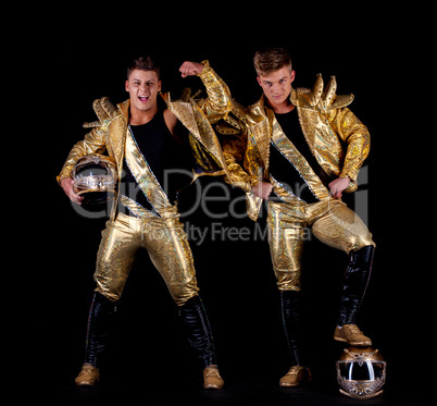 Handsome guys posing in golden dancing costumes