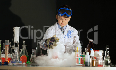 Image of cute boy experimenting in physics lab