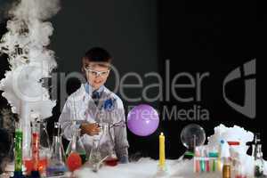 Smiling little scientist experimenting in lab