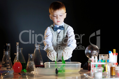 Cute schoolboy watching reaction of reagents