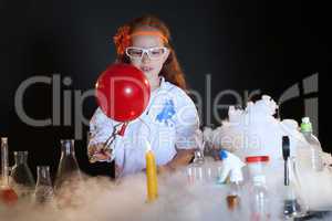 Image of cute little schoolgirl watching reagents