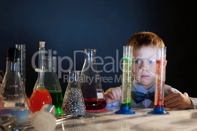 Handsome little boy posing with test-tubes
