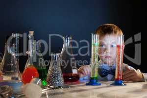 Handsome little boy posing with test-tubes