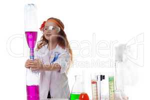 Attentive schoolgirl conducting experiment