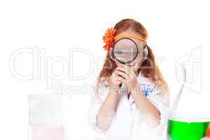 Cute little scientist looking through magnifier