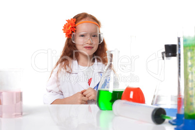 Smiling red-haired schoolgirl posing in lab