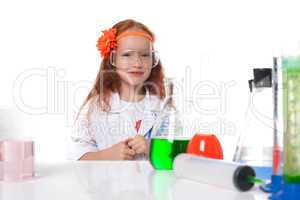Smiling red-haired schoolgirl posing in lab
