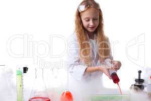 Image of attentive little scientist mixes reagents