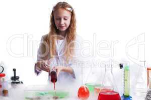 Curious schoolgirl mixes reagents in studio