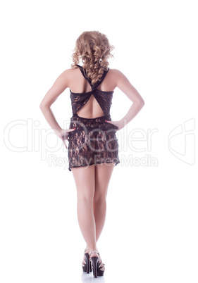 Sexy curly-haired model posing back to camera