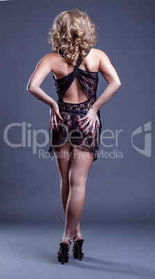 Charming slender woman posing in erotic negligee