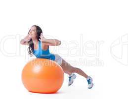 Pretty sportswoman exercising with orange ball