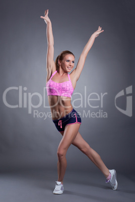 Muscular smiling girl posing in studio