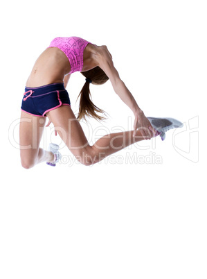 Studio shot of flexible athletic girl jumping