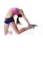 Studio shot of flexible athletic girl jumping