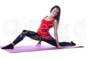 Cheerful athletic girl posing on gymnastic mat