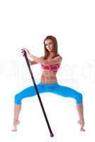 Flexible athletic model posing with fitness bar