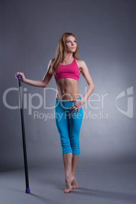 Studio shot of muscular strong woman with fitbar