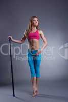 Studio shot of muscular strong woman with fitbar