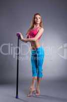 Pretty slim girl standing on tiptoe with fitbar