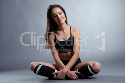 Relaxed smiling brunette posing in sportswear