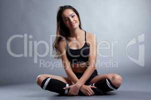 Relaxed smiling brunette posing in sportswear