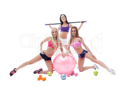 Cheerful pretty sportswomen posing in studio