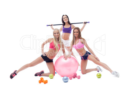 Cheerful pretty sportswomen posing in studio