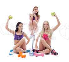 Funny sportswomen posing with sports equipment