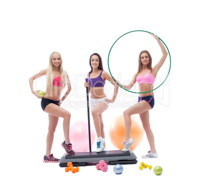 Cute female athletes posing with sports equipment