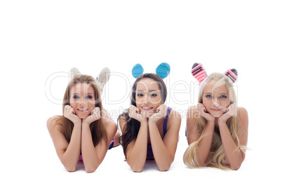 Smiling young female athletes lying in studio