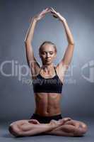 Concentrated blonde meditating in lotus position