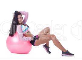 Confident curly brunette posing with sport ball