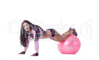Smiling athletic woman posing with pink sport ball