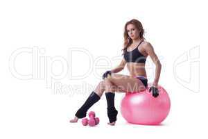 Confident slim woman posing with sport equipment
