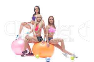 Charming trio of young athletes posing in studio