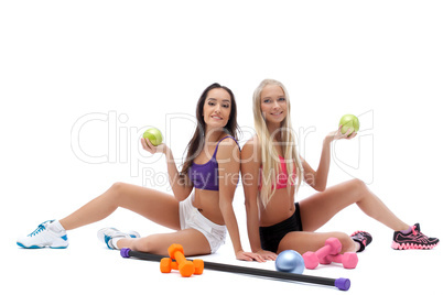 Smiling sporty models posing with gymnastic balls