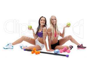 Smiling sporty models posing with gymnastic balls