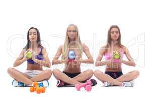 Beautiful focused girls meditating with balls