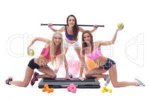 Cheerful sportswomen with gymnastic equipment