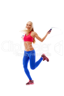 Charming slim blonde jumping with skipping rope