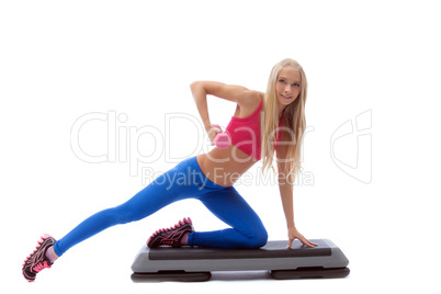 Emotional young blonde doing fitness exercises